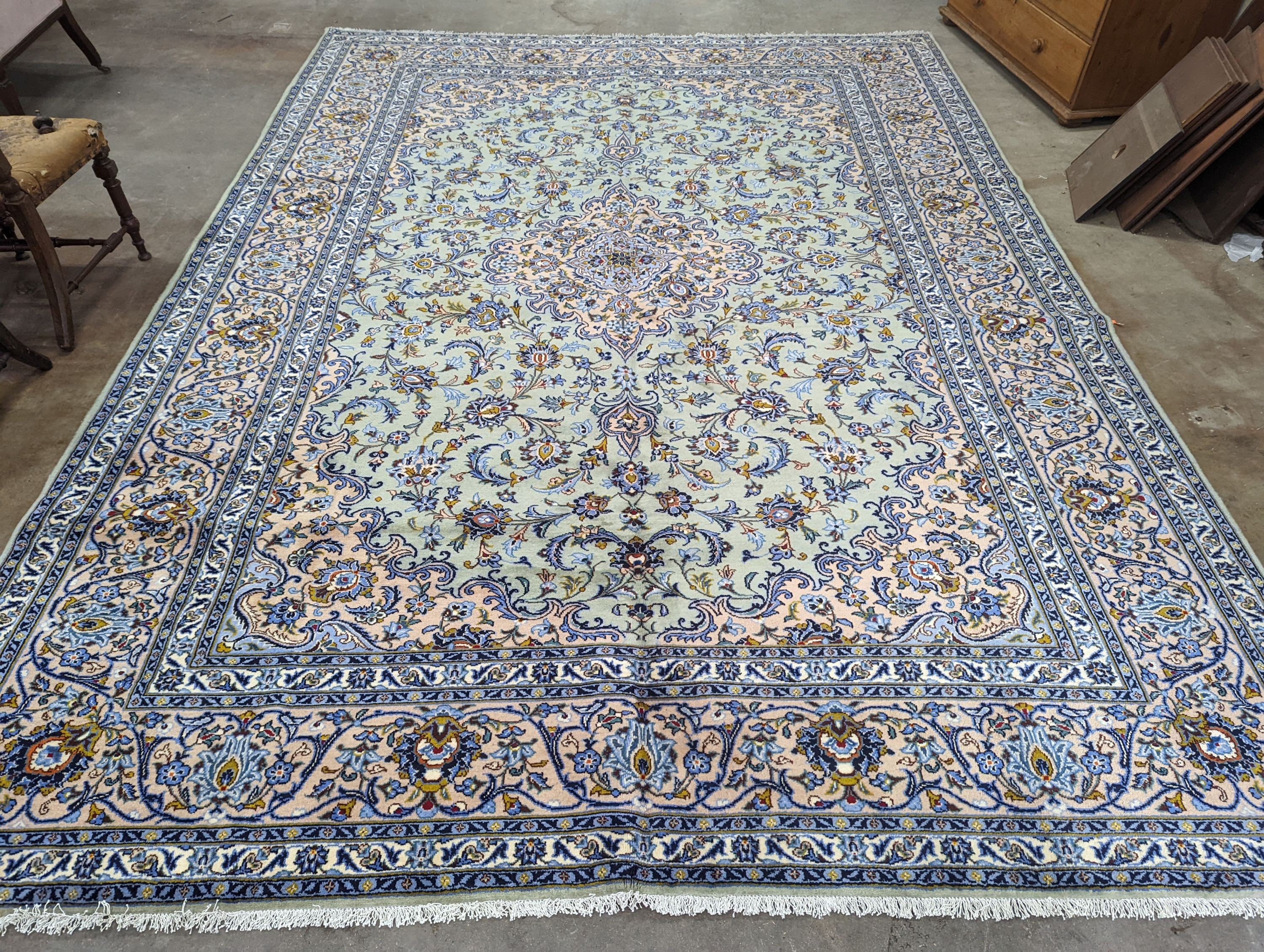 A Kashan pale green ground carpet, 410 x 296cm
